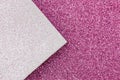 Multicolor paper diagonal background pink, white colors. Top view, copy space. Shiny multicolored festive background