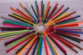 Multicolor pencils forming a color circle isolated on a painted wooden surface background, close up Royalty Free Stock Photo