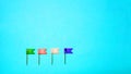 Multicolor plastic flag pins on blue background Royalty Free Stock Photo