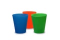 Multicolor plastic glasses, cups blue orange green on isolated w Royalty Free Stock Photo