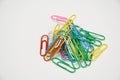 Multicolor plastic paper holders, paperclips on white background. Royalty Free Stock Photo