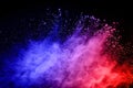 Multicolor powder explosion on black background.