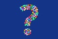 Multicolor question mark made from many tablets, pills and medicines