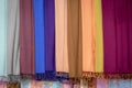 Multicolor of scarves tied on the hanging bar