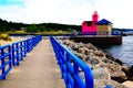 Multicolor scene with a bright pink beacon and a blue fence on the pier. Colorfull Holland Harbor Light, Royalty Free Stock Photo