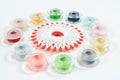 Multicolor sewing bobbin on white background