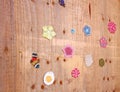 Multicolor small crocheted things on wooden wall Royalty Free Stock Photo