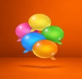 Multicolor speech bubbles on orange square background Royalty Free Stock Photo