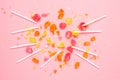 Multicolor sweet lollipops bitten pieces set on pink background