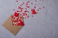 Multicolor sweets sugar candy hearts fly out of craft paper postal envelope. Happy Valentine`s day concept.