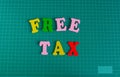 Multicolor Text Free Tax on green mat