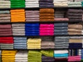 Multicolor towels on shelf in market, sale cotton towels, stack colored cotton towels, a shelf in home row of market