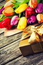 Multicolor tulips bouquet and gift box Royalty Free Stock Photo