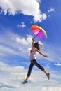 Multicolor umbrella woman jump to sky