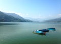 Multicolore tourist boats of Lake Pheva, mountains and clouds Royalty Free Stock Photo