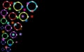 Multicolored abstract shiny beautiful colored neon glowing circles, bubbles, rings with glare of light and bright stars on a black Royalty Free Stock Photo