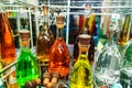 Multicolored alcoholic drinks in glass bottles. Alcohol to decorate the festive table, stands in the home bar. Close-up Royalty Free Stock Photo