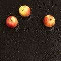 Multicolored apples on star galaxy granite counter