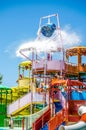 Multicolored Aqua Park with Water Slides, Pools and a Big Bucket on Top. Splashing Water Attraction on a Sunny Day Royalty Free Stock Photo