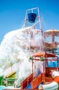 Multicolored Aqua Park with Water Slides, Pools and a Big Bucket on Top of the Construction. Splashing Water Attraction Royalty Free Stock Photo