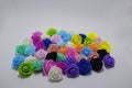 Multicolored artificial roses on a white background Royalty Free Stock Photo
