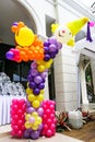 Multicolored balloons arranged in a big clown. Set in a Feast