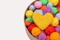 Multicolored balls of yarn, a yellow woolen heart in a round box Royalty Free Stock Photo