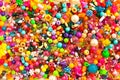 Multicolored beads background. Mix of shiny different size, shape jewelry glass and plastic bead. Royalty Free Stock Photo