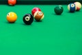 Multicolored billiard balls on green cloth. Lighting fluorescent light