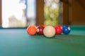 Multicolored billiard balls scattered in a chaotic order on the pool table