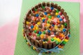 Multicolored birthday Pinata cake stuffed with sweets inside.