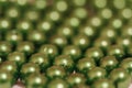 Multicolored blanks for beads close-up. Macro photo on a red background