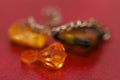 Multicolored blanks for beads close-up. Macro photo on a red background