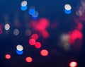 Multicolored bokeh background. Defocused abstract red, blue and white light circles. Dark Christmas background. Royalty Free Stock Photo