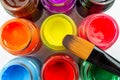 Multicolored bottles poster color and paintbrush  on a white background Isolated Paints in containers . Royalty Free Stock Photo