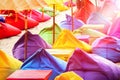 Multicolored bright beach umbrellas, ottomans and tables in the beach cafe. Summer multicolored background. Royalty Free Stock Photo