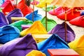 Multicolored bright beach umbrellas, ottomans and tables in the beach cafe. Summer multicolored background Royalty Free Stock Photo