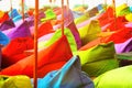 Multicolored bright beach umbrellas, ottomans and tables in the beach cafe. Summer multicolored background.