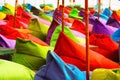 Multicolored bright beach umbrellas, ottomans and tables in the beach cafe. Summer multicolored background Royalty Free Stock Photo