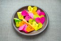 Multicolored bright paper origami hearts with text Love You, kiss, baby, be mine. Many pink, orange, yellow, green, origami paper