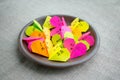 Multicolored bright paper origami hearts with text Love You, kiss, baby, be mine. Many pink, orange, yellow, green, origami paper