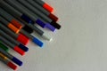 Multicolored bright pencils on white textured paper background. Royalty Free Stock Photo
