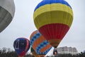 Multicolored bright round colored striped flying balloons with a basket against the sky Aeronautics festival