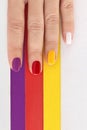 Multicolored bright saturated manicure on short nails close-up. Royalty Free Stock Photo