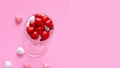 Multicolored candy or Pills in the shape of hearts in wine glass. Concept Valentine`s Day or Medicine, Pharmacy, Cardiology.