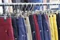 Multicolored casual pants hanging on hanger close up, side view