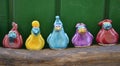 Multicolored ceramic birds on a wooden stand