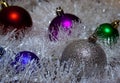 Multicolored Christmas balls in tinsel