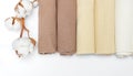 Multicolored clean towels with a branch of cotton on a white background top view with copy space. Texture of cotton, waffle towel,