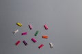 Multicolored clothes pegs on the gray background Royalty Free Stock Photo